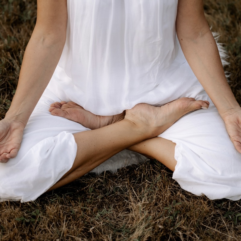 Person sitting cross legged meditating